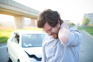 Man feeling pain to the neck after a car crash