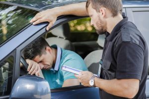 Sad young man in car fined by police officer. Traffic stop. What to do in traffic stop.