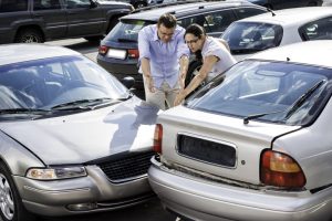 Two drivers arguing after having a parking lot accident.