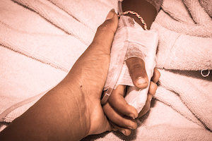 Hospital Bed Holding Hands